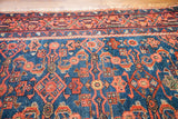 Finely woven texture of indigo blue Malayer rug with coral herati design.