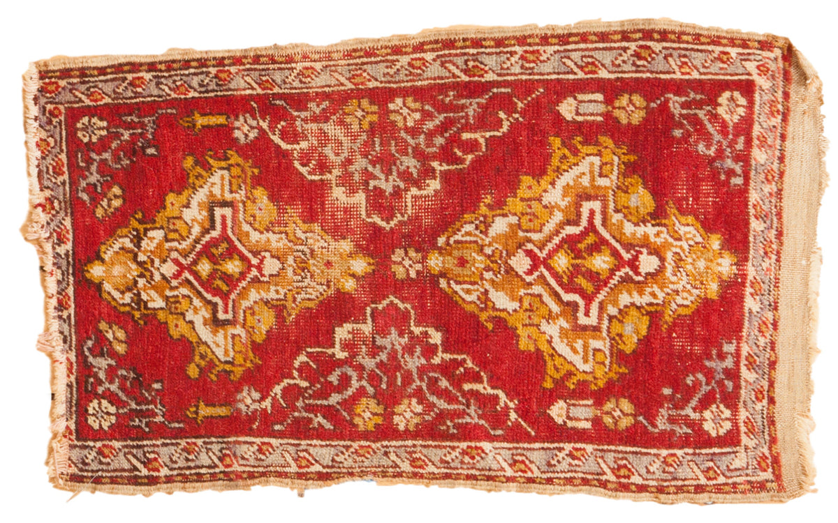 Hand-knotted vintage Turkish scatter rug with vibrant red, golden yellow, and ivory geometric patterns.
