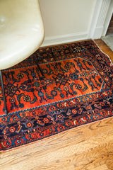 Clearly defined blue Herati motifs on the madder red field of a vintage Persian Engelas rug.
