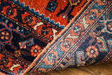 View of the Persian Engelas rug's rich madder red pile and woven back foundation.