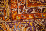 Textured pile with unique orange, mauve, yellow, and silver geometric patterns.