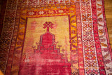 Distressed red prayer niche and golden yellow field of this antique Turkish rug.