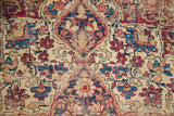 Distressed texture of the antique Kerman's classic blue and red floral motifs.