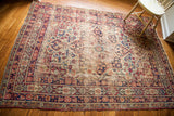 Decorative distressed antique Kerman rug, classic medallion and ruby red, sapphire blue motifs.