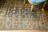 Antique Caucasian rug's abrashed teal-blue field with geometric plants, birds, and serpents.