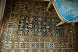 Geometric patterns of an antique Caucasian rug with unusual teal blue and warm earth tones.