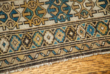 Unusual teal and earth tone geometric patterns on an antique Caucasian rug border.