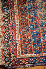 Tattered blue allover design Caucasian rug corner, showing distressed geometric borders and worn fringe.