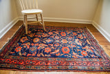 Lovely worn antique Lilihan rug, deep indigo blue with abrashes and whimsical floral design.