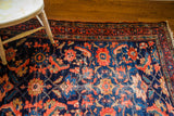 Fine antique Lilihan rug corner, with whimsical coral design, deep indigo, and worn fringe.