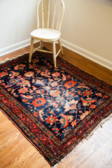 Deep indigo blue field of an antique Lilihan rug, with abrash and whimsical coral motifs.