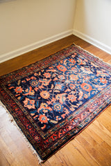 Angled corner of the Lilihan rug, highlighting whimsical coral florals and soft fringe.