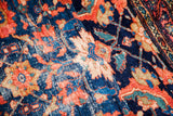 Antique Lilihan rug with whimsical indigo, coral floral pattern and rich abrash.
