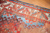 Geometric border and colorful worn pile of an old Caucasian rug.