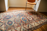 Antique tribal Caucasian rug, whimsical geometric medallions in blues, oranges, and earth tones, 4'5