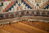Textured flatweave edge of the antique Caucasian rug with earth tones and tribal motifs.