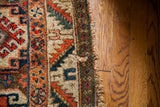Antique Caucasian Tribal rug edge, featuring geometric motifs in brown, red, and blue earth tones.