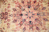 Blanched pile detail of antique Kerman rug, cochineal red traditional scrolling medallion.