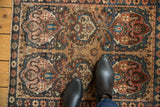 Antique Farahan Sarouk rug displaying unusual cloudband motifs, nuanced earth tones and blue abrash.