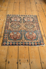 Antique Farahan Sarouk mat corner with abrash blue border, earth tone cloudband motifs, and fringe.