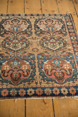 Dark blue floral border and earth tone cloudband motif on antique Farahan Sarouk mat.