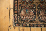 Antique Farahan Sarouk mat corner, showing detailed pink cloudband motif and dark floral border.
