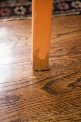 Chippy orange paint detail on a vintage Alvar Aalto style stool leg.