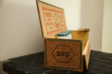 Antique Cuban cigar box front, displaying '250' graphic, green border, and rich patina.