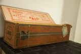 Antique Cuban cigar box side with green decorative border, torn label, and 