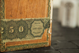Torn green tax stamp with 