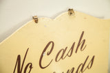 Metal hanging clips fixed to the scalloped top edge of the vintage yellow shop sign.