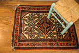 Vintage Persian Engelas rug with plush ivory pile and intricate red, blue patterns.