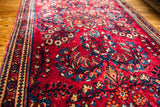 Exceptional detail of a vintage Sarouk rug with ruby red and sapphire blue floral motifs.