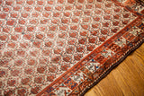 Unique rose border of this antique Hamadan rug, featuring Kurdish and Karabagh characteristics.
