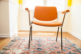 Vintage Pirelli by Castelli DSC chair with bright orange upholstery and armrests.