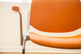 Side view of vintage Pirelli DSC chair's rare orange armrest and aluminum frame.