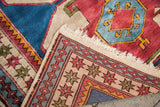 Hand-knotted reverse and geometric borders on vintage Caucasian style Turkish rug corner.