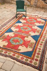 Hand-knotted corner of vintage Caucasian style Turkish rug with geometric star motifs and fringe.