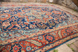 1940s vintage Heriz rug border with saturated rust, navy, and mint green floral motifs.