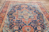 Detail of the vintage Heriz rug's saturated blue field and unique mint green medallion.