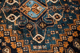 Intricate Southwest Persian tribal rug patterns with deep teal blue and rich earth tones.