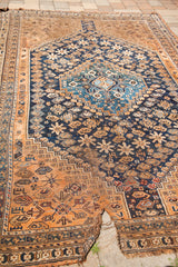Southwest Persian tribal rug's fringed end displaying a prominent tear.