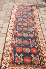 Mid-19th century Persian runner, showing repeating red floral veramin motifs and ivory guard borders.