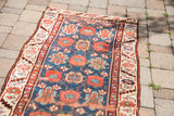 Collector antique Persian runner's blue field with coral floral veramin motif and patterned border.