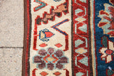 Antique Persian rug border detail: aubergine, red, light blue Veramin floral motif.