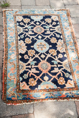 Vintage Lilihan rug corner, with indigo Veramin motifs and light blue-peach border.