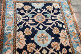 Faded Lilihan rug showing indigo, peach, and aqua floral pattern details.