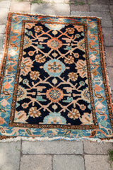 Vintage Lilihan rug fringe and corner, with indigo blue field and Veramin floral design.