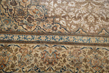 Distressed vintage Tabriz rug, faded brown field with ivory, blue, and rust border motifs.