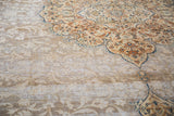 Distressed texture and subtle floral field of the Tabriz rug, with rust and blue accents.